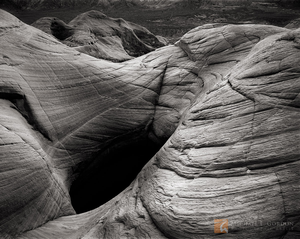 A dark and mysterious pothole high on a Entrada sandstone dome.&nbsp; Logos and watermarks are not found on any printed product...