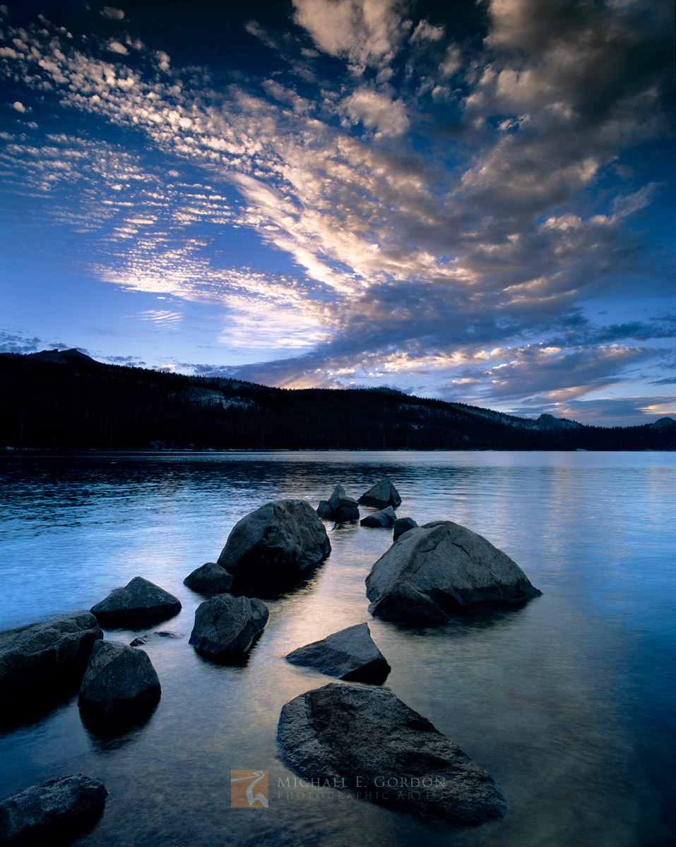 A blue sunset falls over the pine forest and granite domes of Courtright Reservoir, Sierra National Forest.&nbsp;Logos and watermarks...