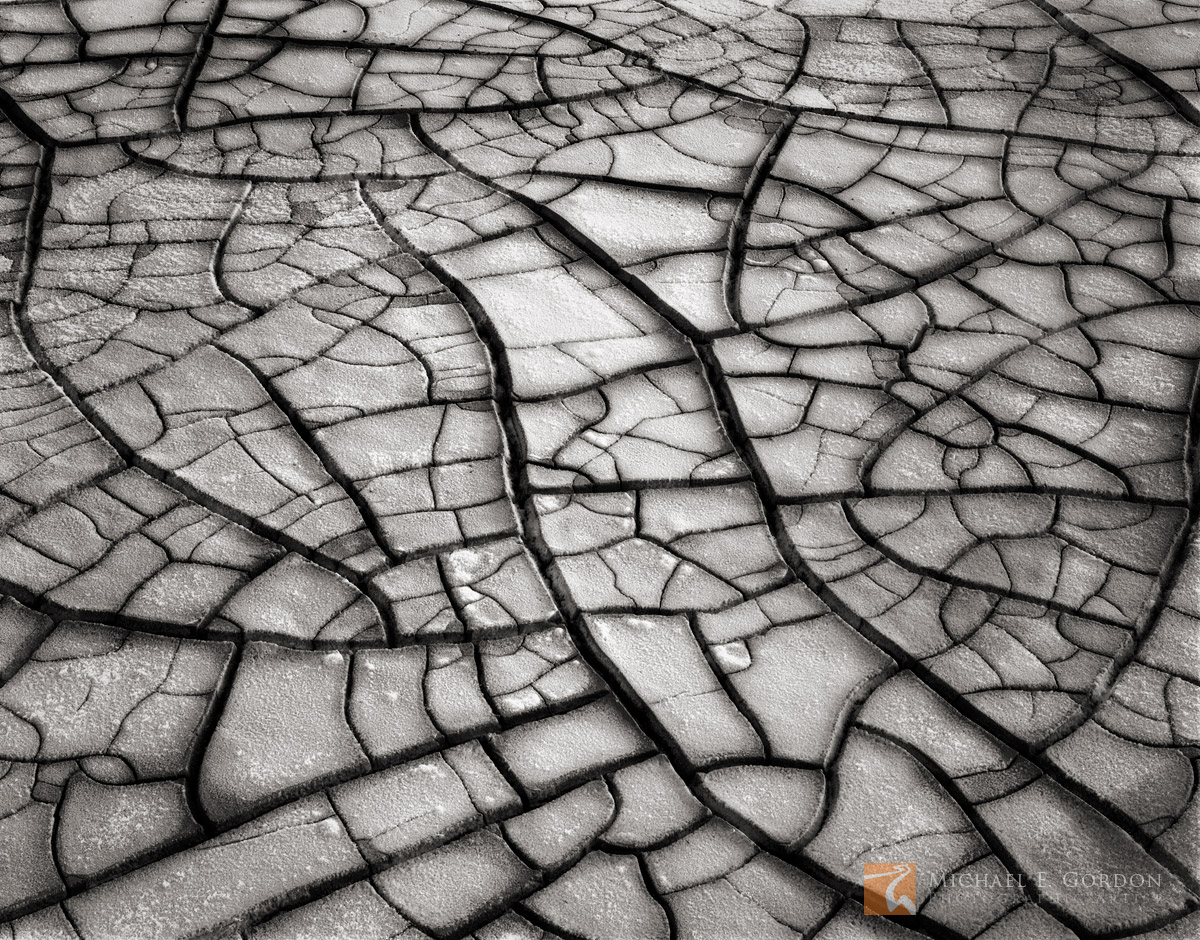 Well-figured cracks and fractures on the sodium chloride&nbsp;salt encrusted mud flats of Badwater Basin.Logos and watermarks...