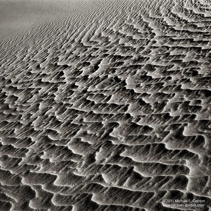 Patterns and shadows on sand dunes.