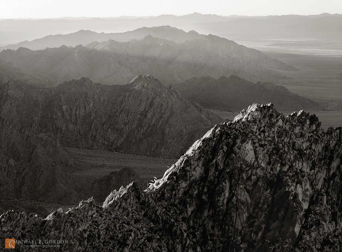 Mojave and Colorado (Sonoran) Desert ridges and mountain ranges recede into the distance in early morning light. "Range after...