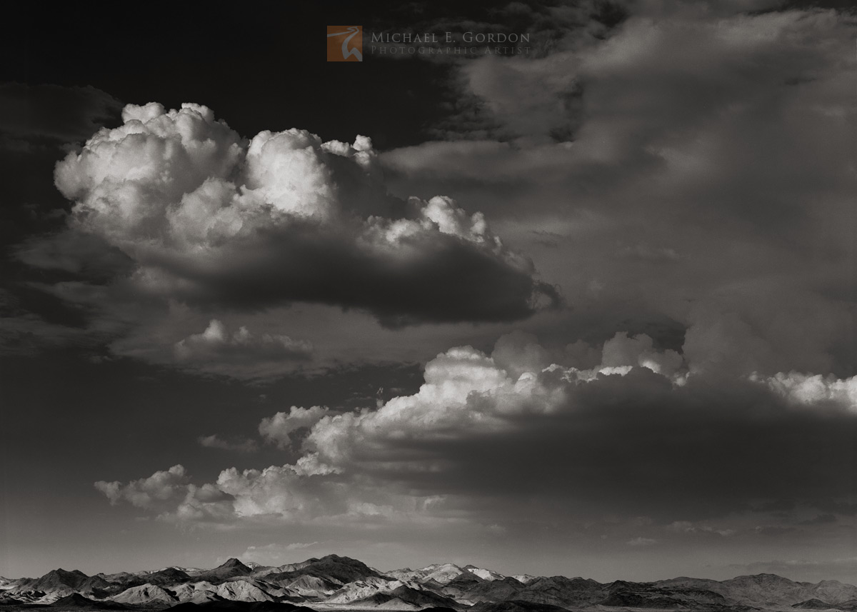 Dissipating summer monsoon clouds over the Cady Mountains at sunset.&nbsp;Logos and watermarks are not found on any printed product...