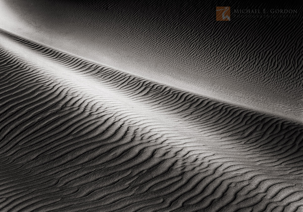 Light and shadow&nbsp;play on wind sculpted sand dunes.&nbsp;Logos and watermarks are not found on any printed product. This...