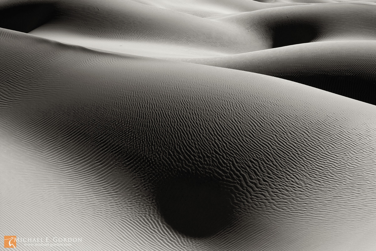 Abstract sand dune forms and shadows resemble sunbathing beauties.&nbsp;